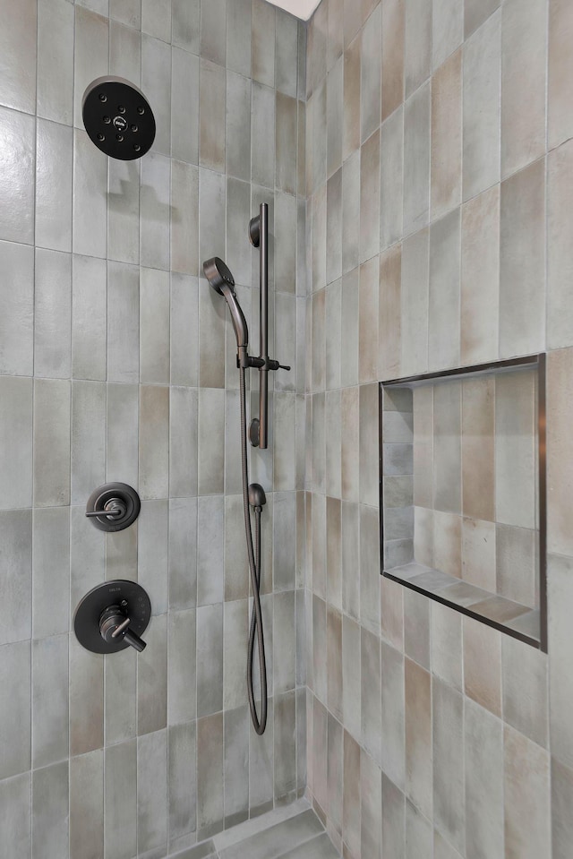 bathroom with tiled shower