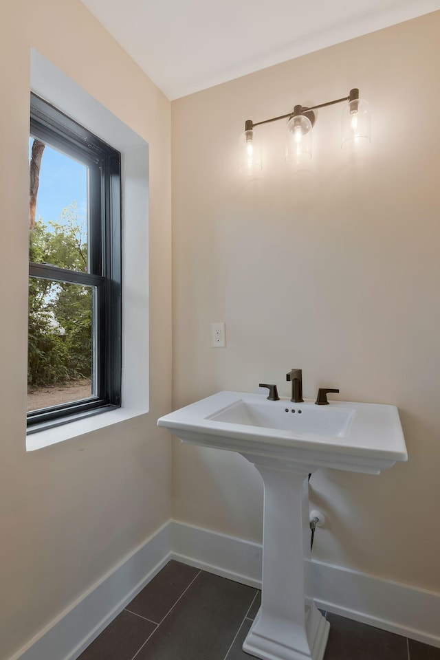 bathroom featuring tile patterned floors, sink, and a healthy amount of sunlight