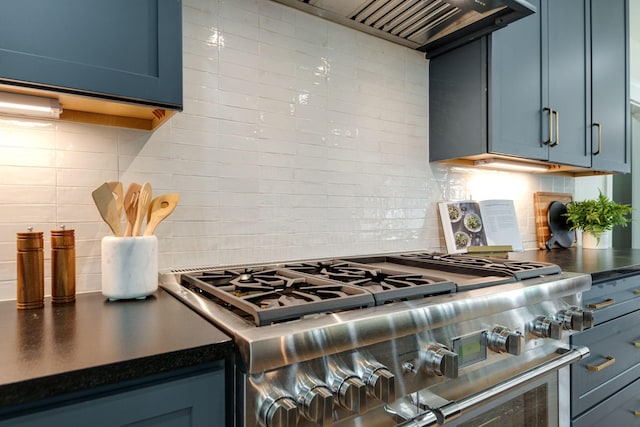 kitchen featuring decorative backsplash, high end stainless steel range, custom range hood, and blue cabinets