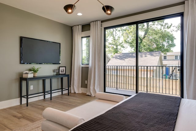 bedroom featuring hardwood / wood-style flooring and access to outside