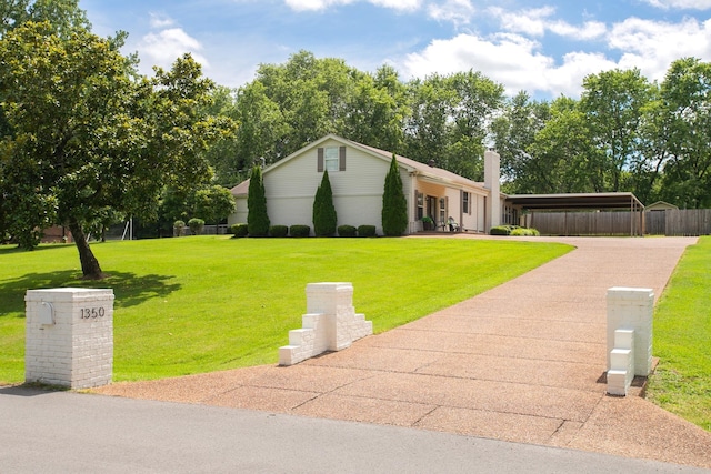 view of front of house featuring a front yard and a carport