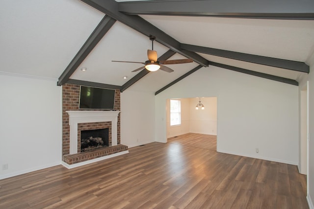 unfurnished living room featuring vaulted ceiling with beams, a brick fireplace, dark hardwood / wood-style flooring, and ceiling fan with notable chandelier