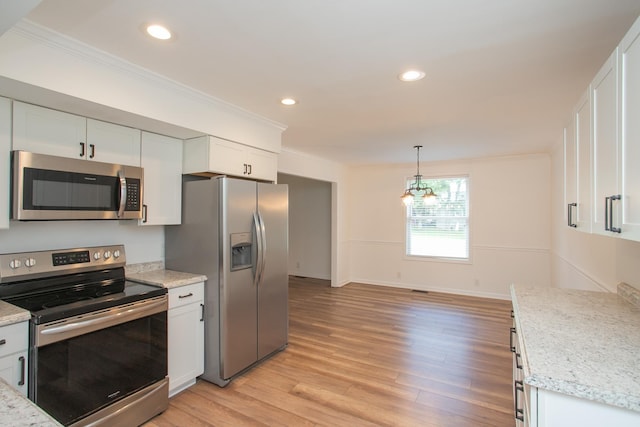 kitchen featuring light stone countertops, pendant lighting, white cabinets, and stainless steel appliances