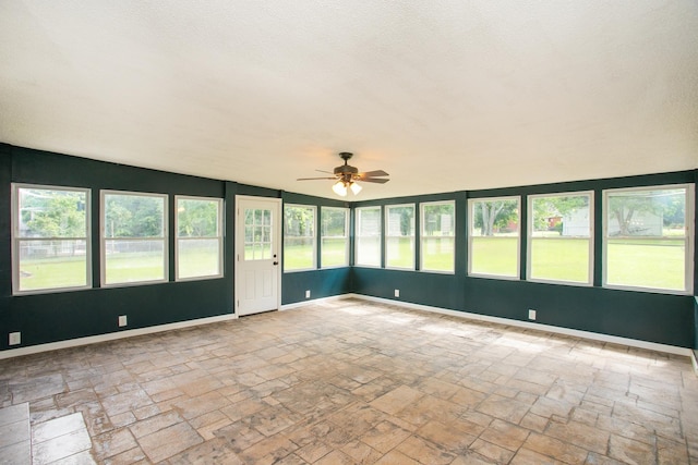 unfurnished sunroom featuring vaulted ceiling and ceiling fan