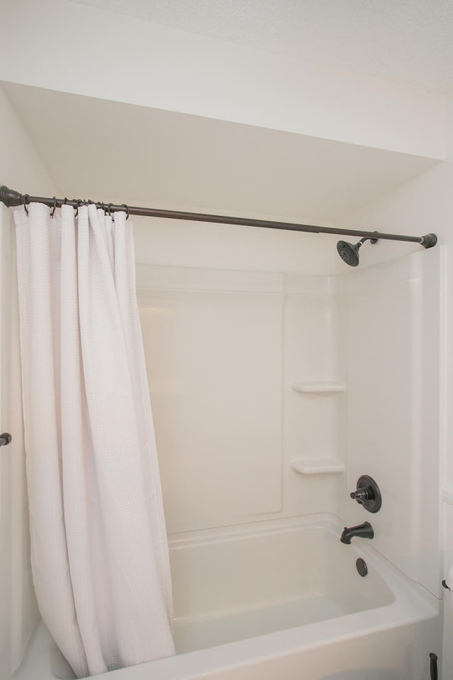 bathroom featuring shower / tub combo with curtain