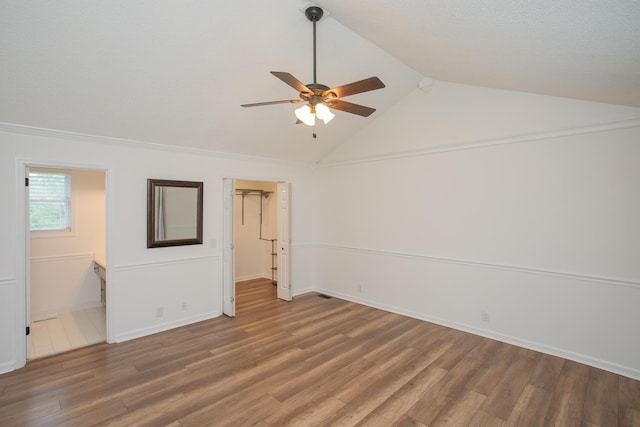 unfurnished room featuring ceiling fan, vaulted ceiling, and dark hardwood / wood-style floors