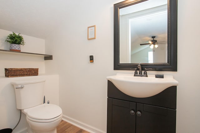 bathroom featuring toilet, hardwood / wood-style floors, ceiling fan, a textured ceiling, and vanity