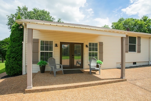 entrance to property with french doors and a patio