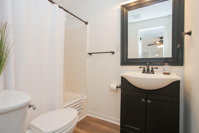 full bathroom with toilet, vanity, ceiling fan, hardwood / wood-style flooring, and shower / bath combo with shower curtain