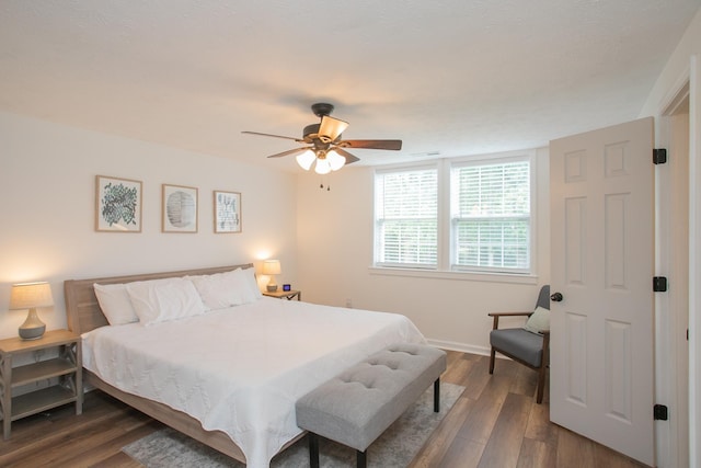 bedroom featuring ceiling fan and dark wood-type flooring