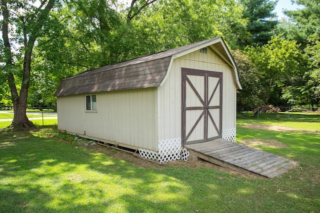 view of outbuilding with a lawn