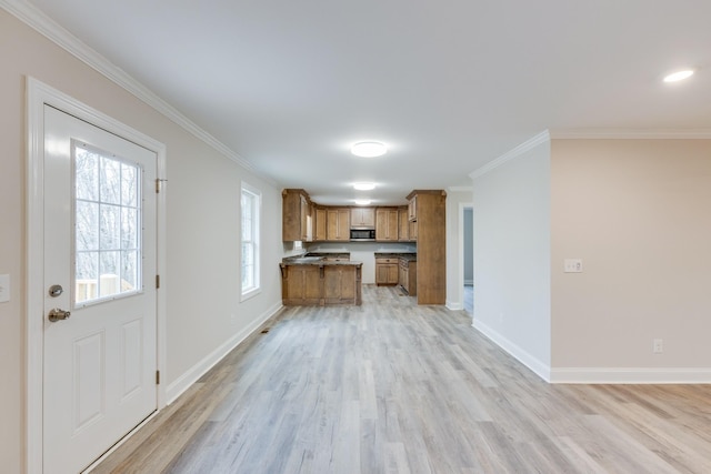 124 Lookout Ln, Pulaski, TN 38478 - kitchen featuring open floor plan, ornamental molding, stainless steel microwave, and brown cabinets