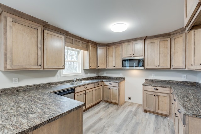 124 Lookout Ln, Pulaski, TN 38478 - kitchen with dark countertops, light brown cabinetry, appliances with stainless steel finishes, a sink, and light wood-type flooring
