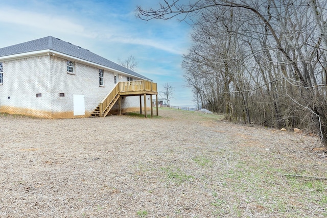 124 Lookout Ln, Pulaski, TN 38478 - exterior space featuring a shingled roof, stairs, a wooden deck, and brick siding