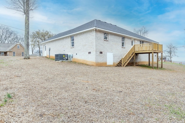124 Lookout Ln, Pulaski, TN 38478 - back of property with a deck, cooling unit, brick siding, roof with shingles, and stairway