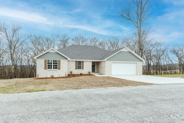 ranch-style house with driveway, roof with shingles, an attached garage, and brick siding