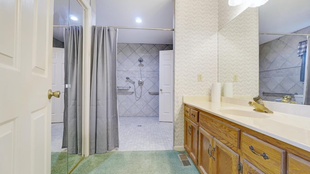 bathroom featuring tile patterned floors, vanity, and curtained shower