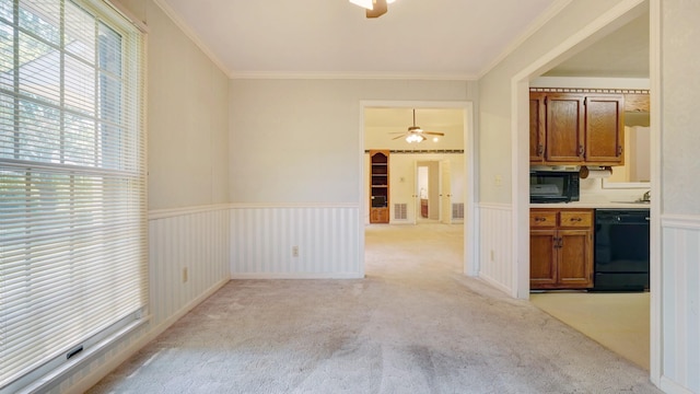 interior space with light colored carpet, ceiling fan, ornamental molding, and black appliances