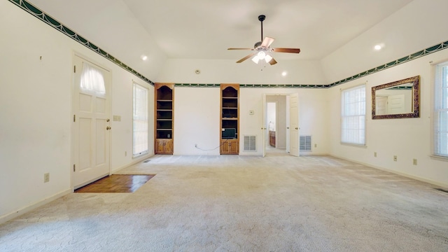 entryway with light carpet, ceiling fan, and lofted ceiling