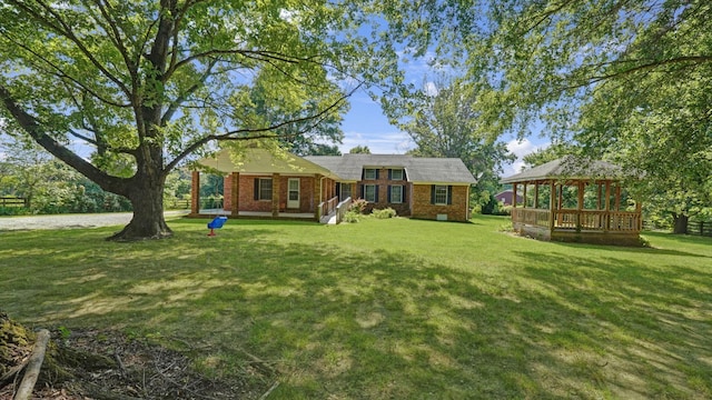 view of front of house featuring a front yard and a gazebo