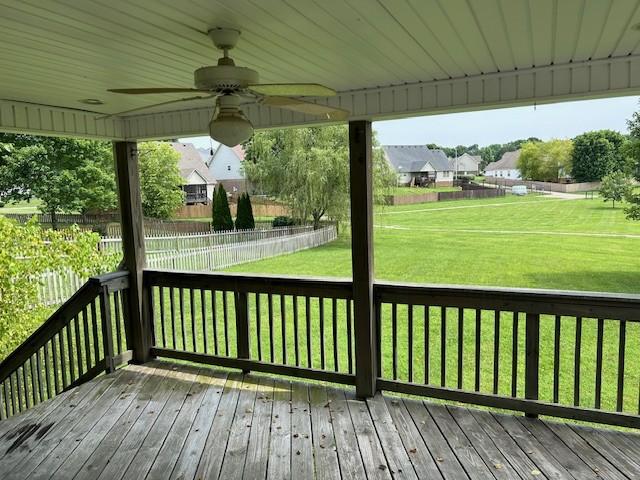 deck featuring ceiling fan and a yard