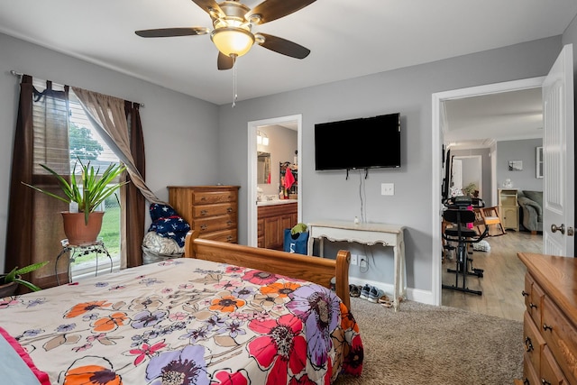 bedroom with ensuite bath, ceiling fan, and light wood-type flooring