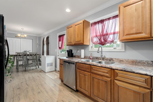 kitchen featuring light wood-type flooring, black fridge, stainless steel dishwasher, sink, and an inviting chandelier