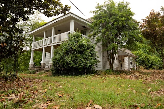 view of side of home with a balcony