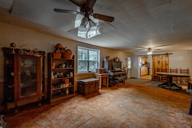 office space with ceiling fan, a barn door, and carpet floors