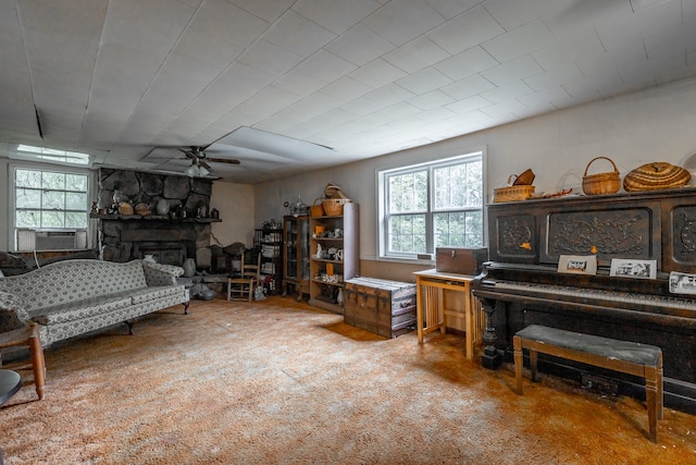 misc room with carpet flooring, a stone fireplace, ceiling fan, and cooling unit