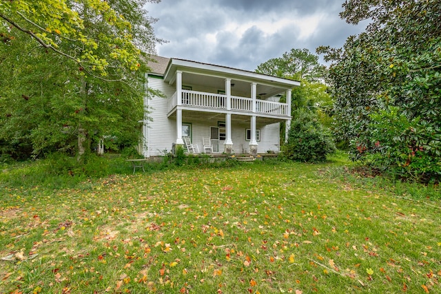 view of front facade with a balcony, covered porch, and a front yard