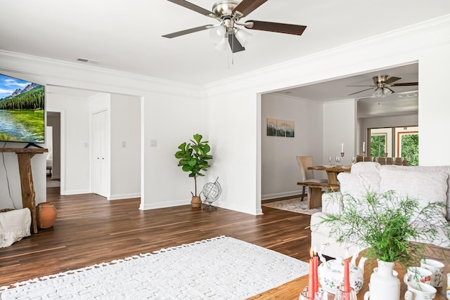 living room with ceiling fan, dark hardwood / wood-style floors, and ornamental molding