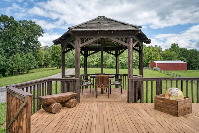 wooden terrace with a gazebo and a lawn