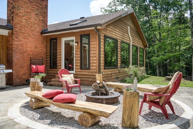 view of patio / terrace featuring a grill and an outdoor fire pit