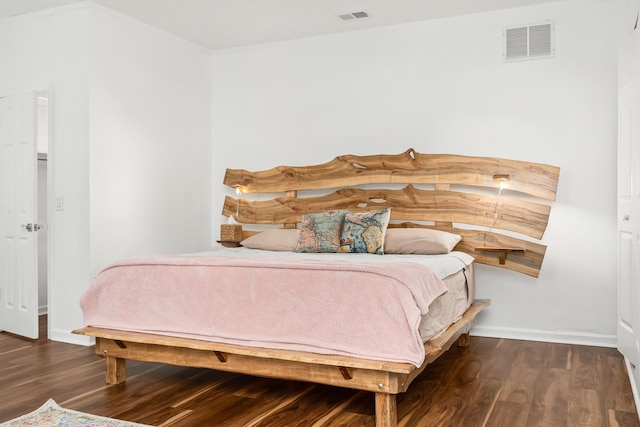 bedroom with dark hardwood / wood-style floors