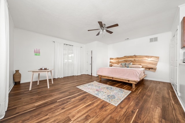 bedroom with ceiling fan and dark wood-type flooring