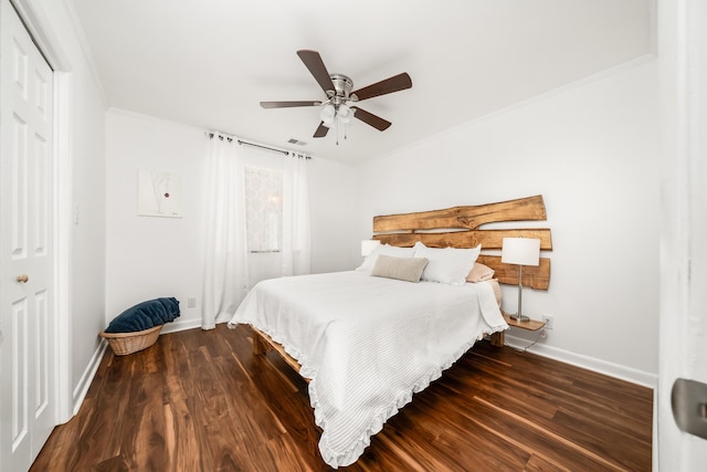 bedroom featuring ceiling fan, a closet, dark wood-type flooring, and ornamental molding