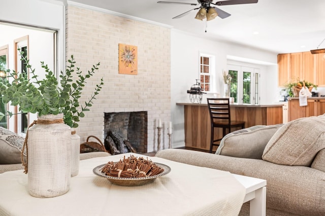 living room with ceiling fan and a fireplace