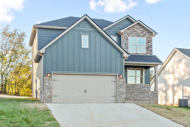 view of front of house featuring central AC, a garage, and a front yard