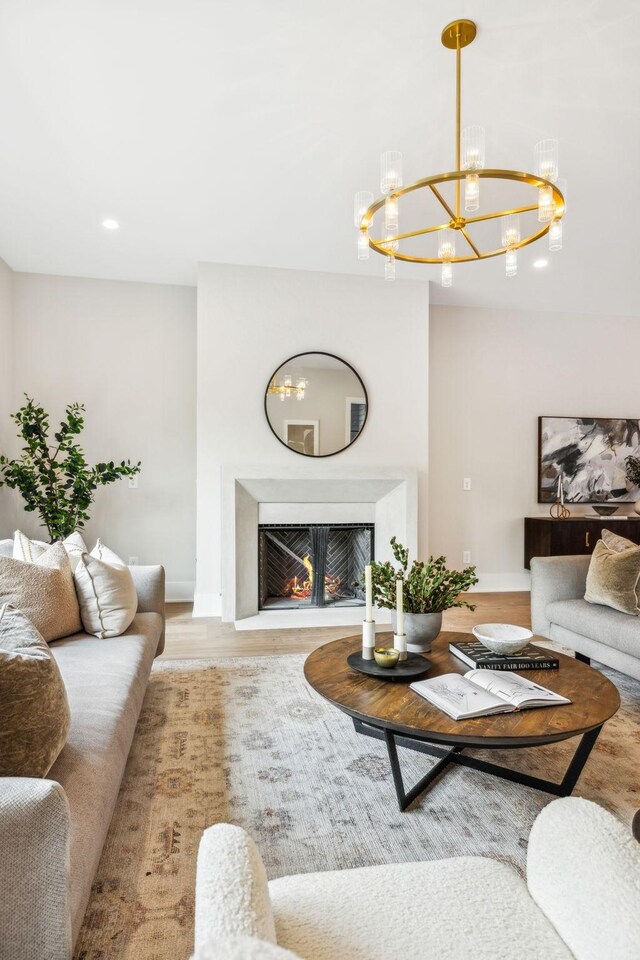 living room featuring light hardwood / wood-style floors and an inviting chandelier