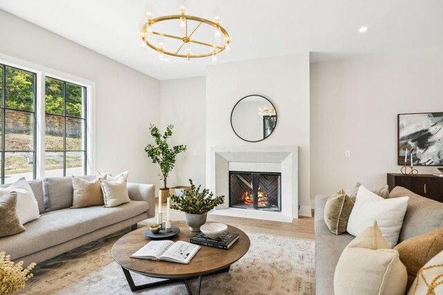 living room featuring light hardwood / wood-style flooring and a chandelier