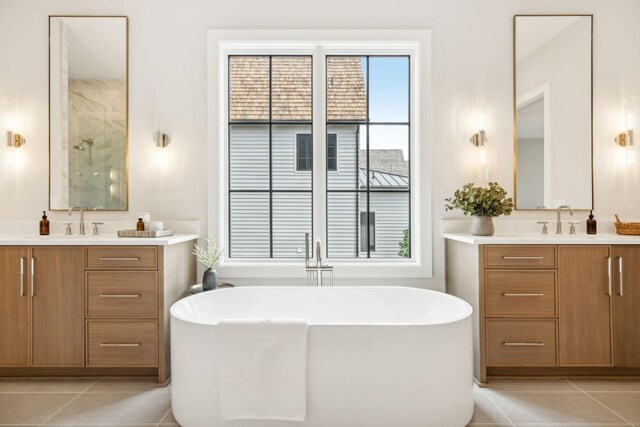 bathroom featuring a healthy amount of sunlight, vanity, and tile patterned floors