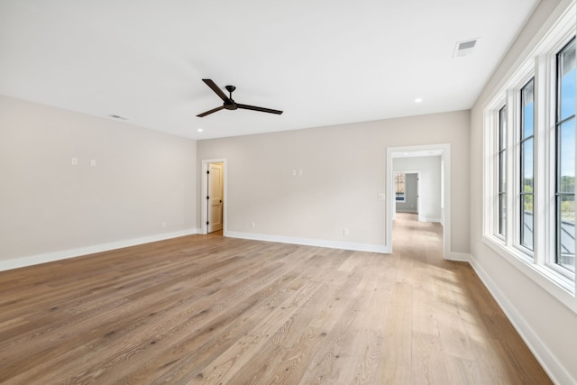 spare room featuring light hardwood / wood-style flooring and ceiling fan