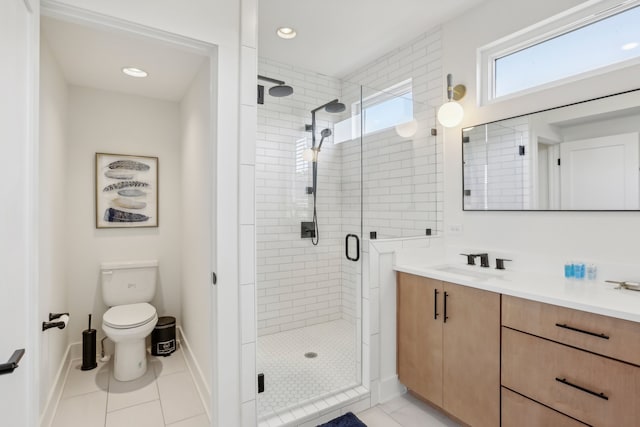 bathroom featuring an enclosed shower, vanity, tile patterned floors, and toilet