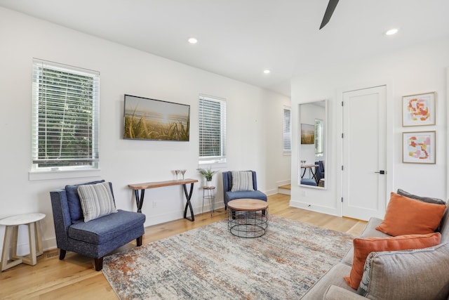 living area with ceiling fan and light wood-type flooring