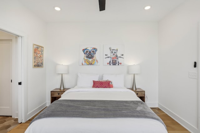 bedroom with ceiling fan and hardwood / wood-style floors