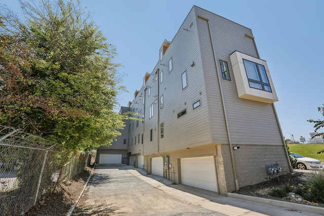 view of side of home with a garage