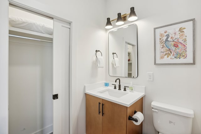 bathroom featuring vanity and toilet