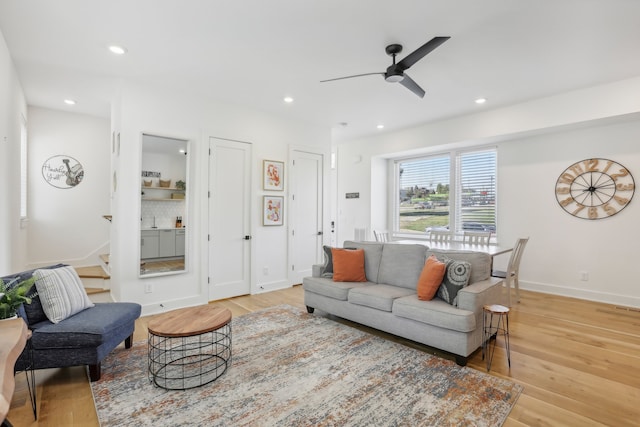 living room featuring ceiling fan and light wood-type flooring