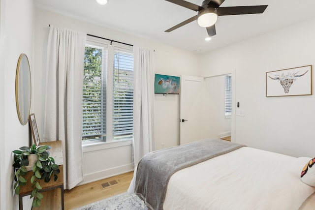 bedroom with light hardwood / wood-style floors and ceiling fan